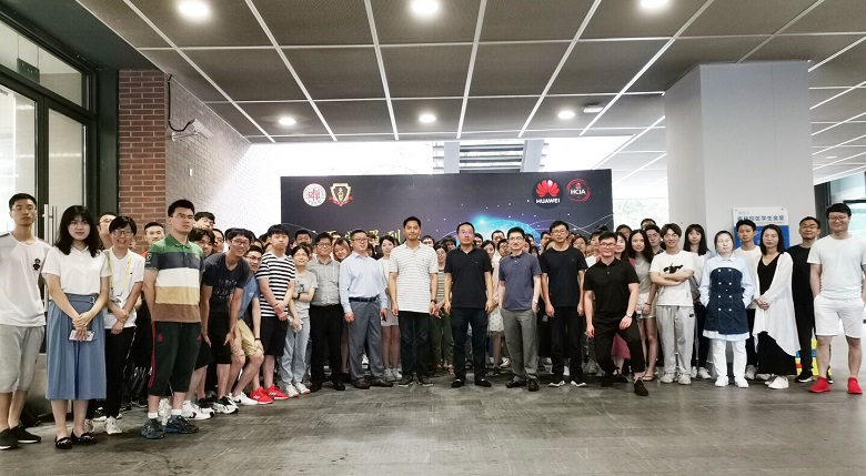 Professors, students, and Huawei staff gather at Fudan University, celebrating their healthcare solutions