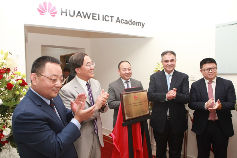 Huawei and BAU executives standing behind a plaque and applauding at the launch of Jordan's first Huawei ICT Academy