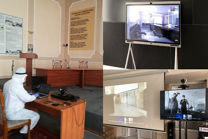 A medical worker in full PCR clothing using a HUAWEI IdeaHub videoconferencing platform to conduct remote telemedicine
