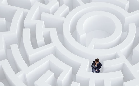 A man trapped in a white maze, representing difficulties finding ICT talent, for an article about Huawei's talent ecosystem
