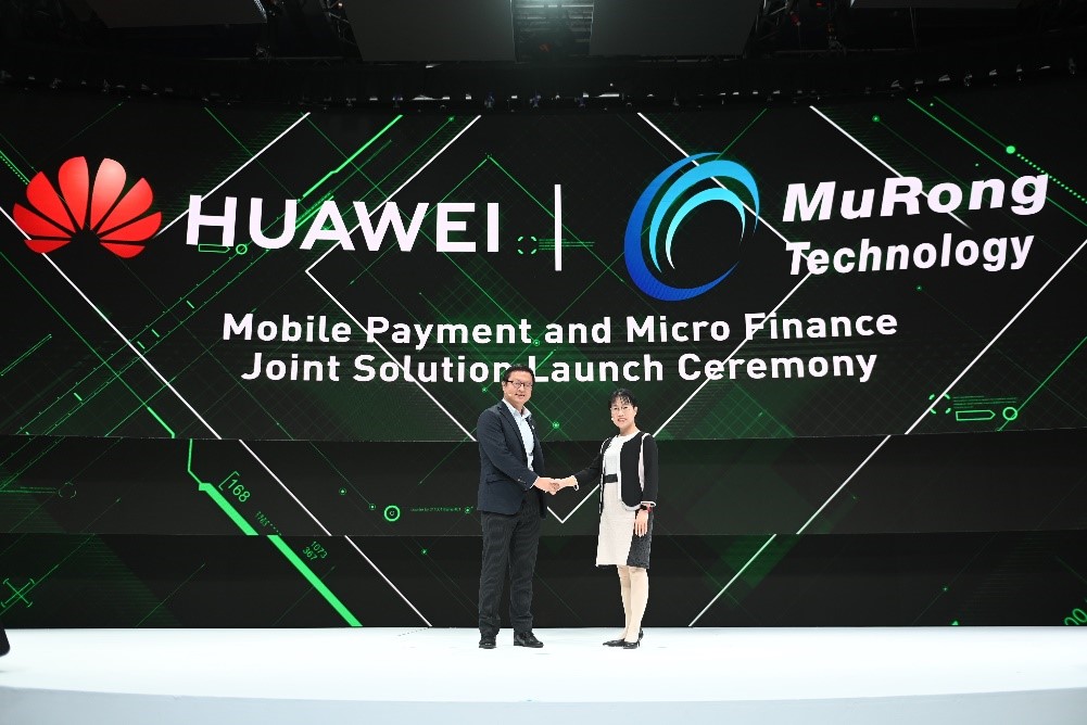 The representatives from Huawei and Murong Technology are shaking hands at  Mobile Payment and Micro Finance Joint Solution launch ceremony. 
