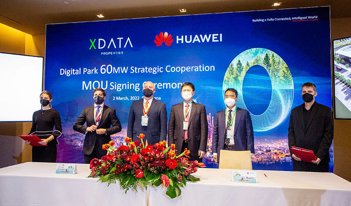 XData and Huawei executives gathered behind a desk to mark the signing of an MOU at MWC Barcelona 2022