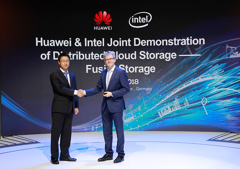 Huawei's Hu Yuhai and Intel Deutschland GmbH's Markus Leberecht shake hands on stage at CeBIT 2018