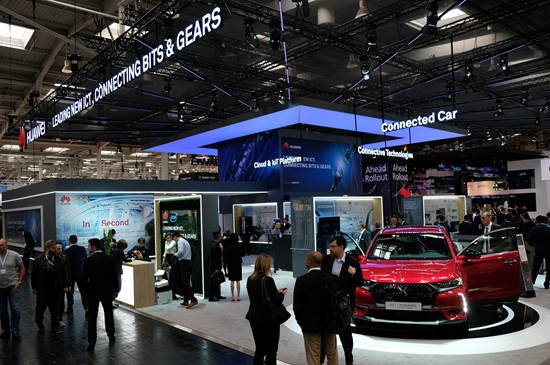 Huawei's booth with a red DS 7 CROSSBACK automobile and various visitors at HANNOVER MESSE 2018