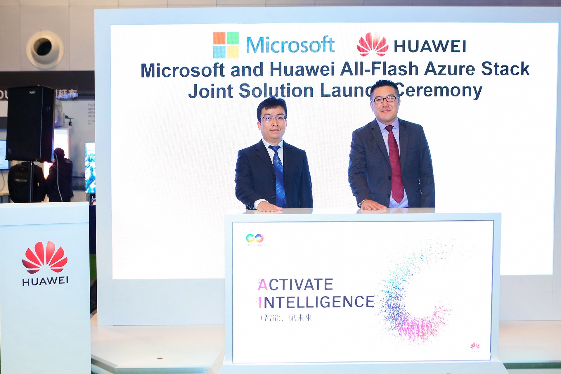 Two executives standing behind a podium at the Microsoft and Huawei All-Flash Azure Stack Joint Solution launch ceremony